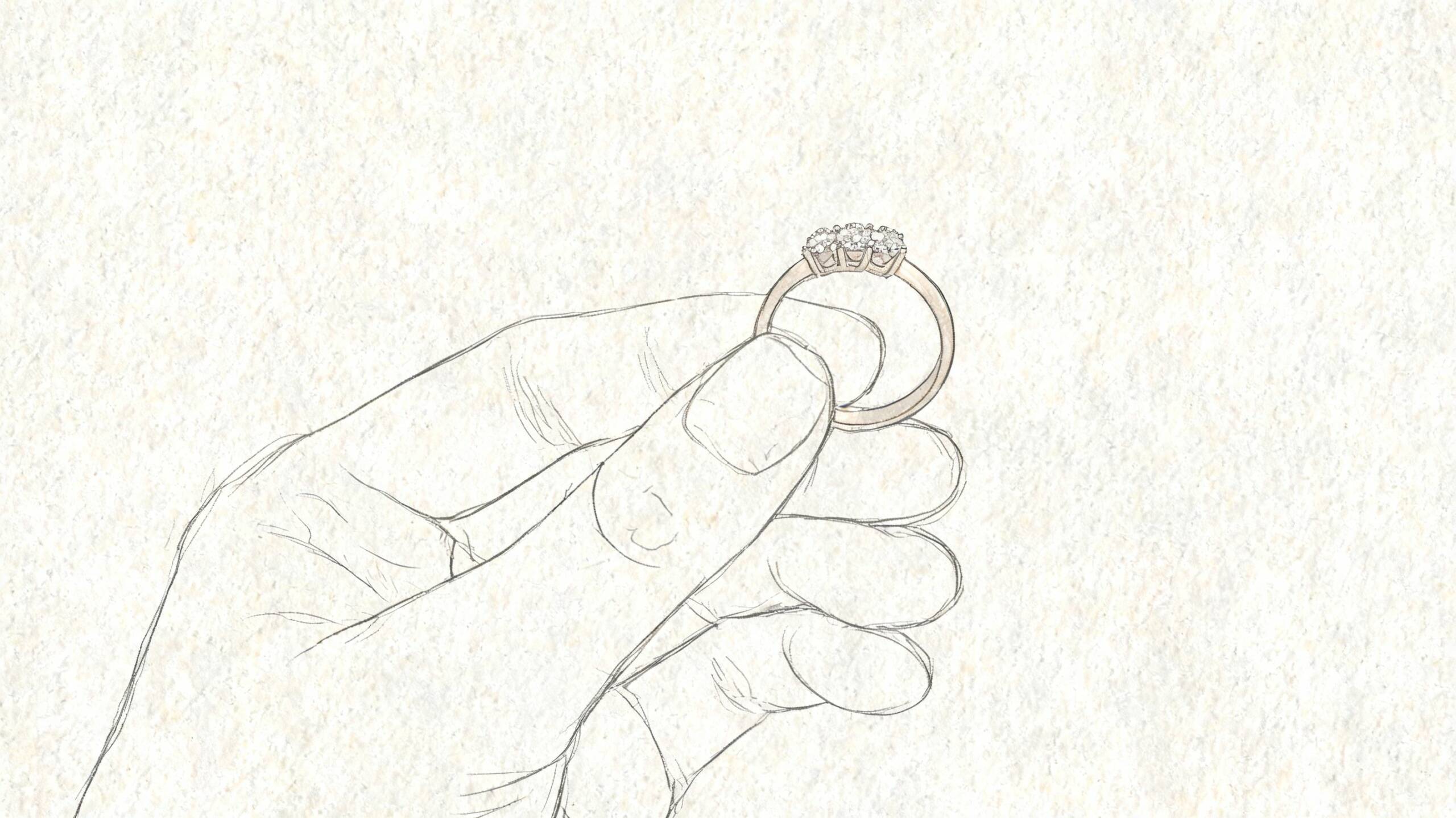 En hand som håller upp en elegant ring med tre diamanter mot en ljus och texturerad bakgrund.